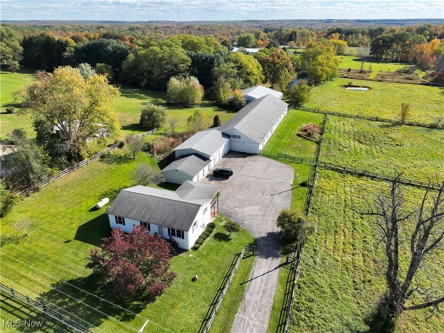 Here is your opportunity to own a horse property within 30 miles of Mahoning Valley Race Course, Thistledown Race Track, Northfield Park and approximately 70 miles to Mountaineer Racetrack in WV.  The barn has 17 stalls, hay loft, a sawdust room, tack room, indoor paddock, and an enclosed hot walker. The 7.66 acre lot features three pastures and a pond with two ramps for exercising your horses. The Ranch style home on the property has been freshly painted and new carpet has been laid, and features 3 bedrooms, 2 full baths with 1232 square feet of living space built in 1996. The main level of the house includes an eat in kitchen, living room with carpet, full bath and all three bedrooms. The unfinished basement holds an additional full bath, laundry, newer furnace (2023), newer hot water tank, and water softener system (approx 2022). Propane services the house and there is a Generac Generator. Exterior features include a 3 car garage with electric door openers and concrete floors. Then an additional garage with two regular height doors, and one 10 ft door with plenty of turn around space in the paved driveway. Ravenna mailing, Charlestown Township, Southeast LSD. Come check out this one-of-a-kind opportunity in Northeast OH.