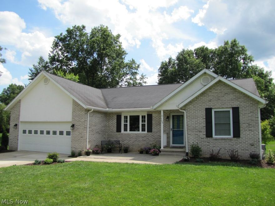 Contemporary Construction, Woodridge Schools, Desirable neighborhood.  Generous concrete driveway with ample parking.  Brick front, new paver patio, covered front entry, Vaulted ceilings in the living room open to eat in kitchen, gorgeous cabinetry featuring auto closing drawers and crown molding, large pantry with pull out shelving, gorgeous view from the kitchen window and the dining area. Huge deck runs the length of the house, plenty of room for a large table and chairs, a sitting area and a grilling area.  Deck is accessed from the master bedroom and the kitchen.  Huge yard is mostly cleared although goes well into the woods, there ample space for playing, gardening and relaxing by the bonfire. The master suite features a walk-in closet, french door leading to the deck, master bath with ceramic tile, garden tub, shower, vanity with granite counters.  First floor laundry in the hallway is now used as a mudroom.  Hook ups and drains are still there.  This space accommodates a washer