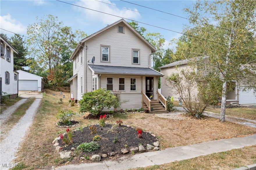 Welcome home to this beautifully updated four bed, two bath colonial in Mogadore Village!! This home is set on a quiet dead - end street with walking distance to neighborhood amenities, schools and restaurants.  Leave your coat in covered porch area and step into the spacious living room with open concept dining areas. First floor living with a bedroom and bathroom on the main level. Enjoy the new carpet, flooring, lighting and upgrades throughout!!  Take a break and relax on the private side deck and patio. This home is full of charm with built ins and storage at every turn. View today!!