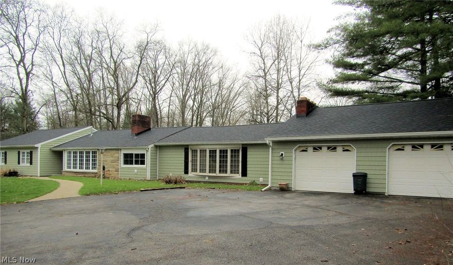 A unique property close to everything but sitting high on a hill with a view of it's own pond which is located down the hill near the road. A winding driveway brings you up to the house and provides ample parking.  The home is a large ranch style with an oversized garage. The double garage includes a workshop area.  The house includes 3 bedrooms one of which is the owner's suite complete with a walk in closet, an additional closet and an updated full bath with jacuzzi style tub, seperate shower and double sinks.  A second full and updated bath is located down the hall and services the other 2 bedrooms.  The living room features a large .area and an indoor waterfall feature plus a gas fireplace.  THe kitchen includes hickory cabinets, a new cooktop and a newer dishwasher. There are plenty of cabinets including 3 pantry cabinets.  Off the kitchen is a breakfast room/dinette room with a view of the acreage. Next comes the formal dining room which is perfect for large gatherings.  The laundry room is located off the dining room.  Just when you think you have seen it all, you will enter the oversized family room which includes a second gas fireplace and another huge window.  From the family room, you will find the large, heated double garage complete with a workshop area or extra car storage. This home has new vinyl siding and a new roof.  (both 2 yrs old).  New flooring has been installed in several rooms and the plumbing has been updated.  The gas forced air furnace and central air are 1 yr. old.  This home currently has free gas from a well located on the property but not owned by the seller.  Well & Septic are 3 yrs old.  Property includes 3 parcels which total 14.26 acres. Barn has 2 horse stalls.