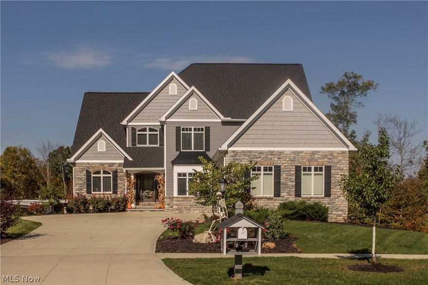 Extraordinary craftsmanship defines this custom designed built home which is located on a private cul-de-sac. Gourmet chef's kitchen with top of the line appliances including double Advantium Ovens. High-end granite throughout the house. Custom built-in bookcases showcase the gas fireplace in the 2 story great room. First floor vaulted master suite includes gorgeous master bath with tiled shower and Whirlpool jetted tub. Unbelievable walk-in closet includes built-in storage with massive space for shoes and clothes. The second floor features two bedrooms with attached bathrooms. All three bedrooms are generously sized. A quaint sitting area overlooks the great room. Attached to sitting room is an unfinished bonus room. Outside entertaining will be easy with 2 Trex balconies and 2 patios. Other features include, central vacuum system ,3/4 inch solid wood floors,double insulation,tankless hot water heater and an in-ground sprinkler system. The unfinished walkout basement is plumbed for a