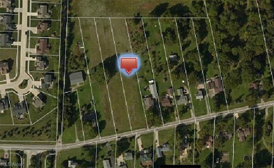 1.025 buildable acres in North Ridgeville. Water and sewer hook ups available.  Gas and Electric. 90 foot frontage required to build but this lot is grandfathered in.  Frontage is 80ft x 580.  sewer hook up is on the other side of the road. water hook up is on the lot side of the road.