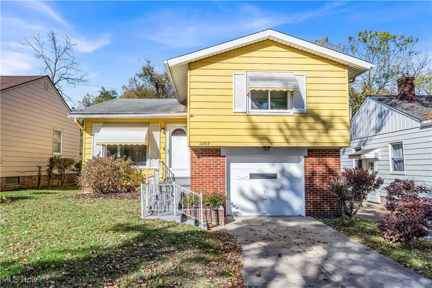Welcome home to this stunning split-level that perfectly blends modern updates with classic charm! Step into the bright and welcoming living room, where a large picture window lets in tons of natural light and gleaming hardwood floors create an inviting atmosphere! The open flow leads right into the kitchen, featuring rich real wood cabinetry, a double-basin sink, and brand-new stainless steel appliances — including a gas stove, refrigerator, microwave, and dishwasher! Head downstairs to the spacious rec room with new luxury vinyl plank flooring and sliding glass doors that open to the enclosed porch and backyard — perfect for relaxing, entertaining, or enjoying the seasons in comfort! From here, you’ll also find access to the attached one-car garage for added convenience! Upstairs, three comfortable bedrooms with beautiful hardwood floors and a full bath provide a cozy retreat! The lower level includes a clean, bright basement with a laundry area, utility sink, washer and dryer hookups, and a convenient half bath! Enjoy peace of mind with a new furnace (2021), newer windows, fresh neutral paint throughout, LED lighting, professional landscaping, and POS compliance! Low-maintenance vinyl siding and thoughtful updates make this home truly move-in ready! Located just moments from the scenic Garfield Park Reservation, you’ll love having trails, picnic areas, and outdoor recreation right nearby! Plus, enjoy quick access to shopping, dining, and major highways for an easy commute! This one won’t last long — schedule your showing today!