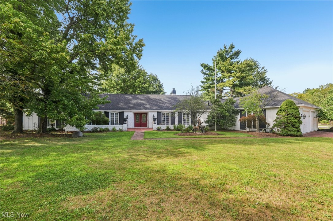 Stunning 4 Bedroom, 2 ½ Bath Ranch home on over a ½ acre (double) lot in scenic Ledgewood of Strongsville. Showcasing a perfect blend of quality & timeless style, this one-of-a-kind home boasts one floor living with a bright, semi-open floor plan with lots of windows for plenty of natural light. As you enter, you are greeted by a beautiful foyer that leads to a spacious Family / Living Room with brand new carpeting. Adjacent is a formal Dining Room or Parlor with stunning European column accents - perfect for relaxing or entertaining guests. The Kitchen overlooks the Great Room / informal dining area and is accented with a beautiful, stacked stone fireplace giving a warm and cozy ambience. The Great Room / dining area also has a wall of windows with sliders that lead to the outdoor patio (for indoor or outdoor dining experience). The gourmet Kitchen also features granite counters, beautiful white cabinetry, breakfast bar, stainless appliances, and lots of storage. The spacious Owner’s Suite features double closets, sliders to a private deck and an en-suite full bathroom with double sinks and walk-in shower. Three additional bedrooms with lots of closet space share a full main bathroom (with two sinks and tub/shower). Spacious first floor laundry room with sink and above storage cabinets. Brand new roof and freshly painted exterior (August, 2025). Nuetral decor throughout. Two car side load attached Garage. All appliances included. The landscaping is AMAZING with tons of low maintenance perennial plants and flowers, a Gazebo, and plenty of space to relax and enjoy your peaceful backyard retreat all year round. The Ledgewood community offers many amenities including a clubhouse, Olympic sized pool, tennis and basketball courts, picnic area & playground all within a beautiful park-like setting.