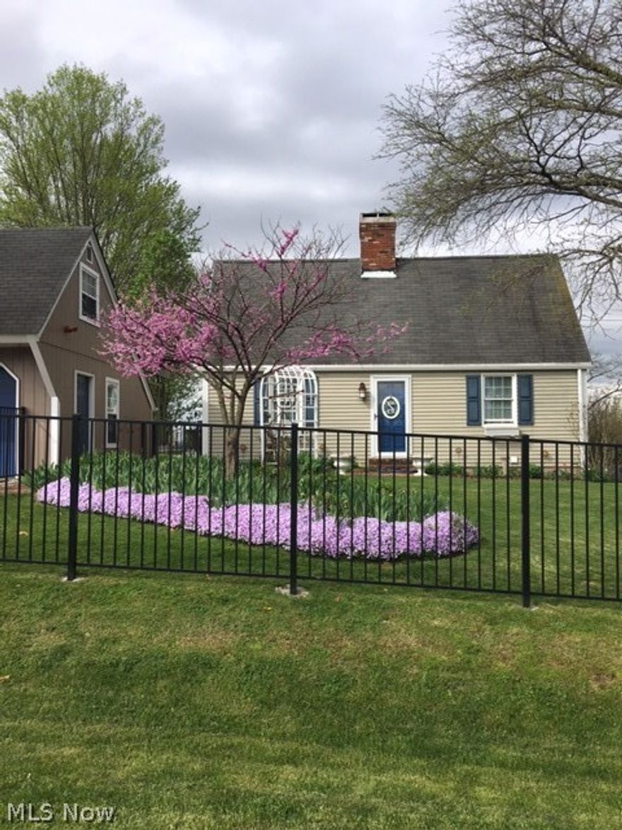 This darling, 1.5 story home offers over an acre of fenced in yard, a new roof, and all around "at home" feeling. Step inside onto the beautiful maple hardwood floors into the kitchen and enjoy the brand new white appliances and ceramic tile countertops. From the kitchen step outside onto the newly built 3 tiered deck and enjoy the beautiful view of the very well and upkept landscaping! First floor of the home offers a spacious master suite and a large living room and dining area with wood burning fireplace. Explore the spacious upstairs bedrooms with a full bath. Looking for more room? Step down into the fully, finished basement perfect for a dream man cave or kids play room! Don't forget to check out the two car, detached garage that offer upper storage. Don't let the size fool you, this home offers huge opportunities! This charming home won't last long!
