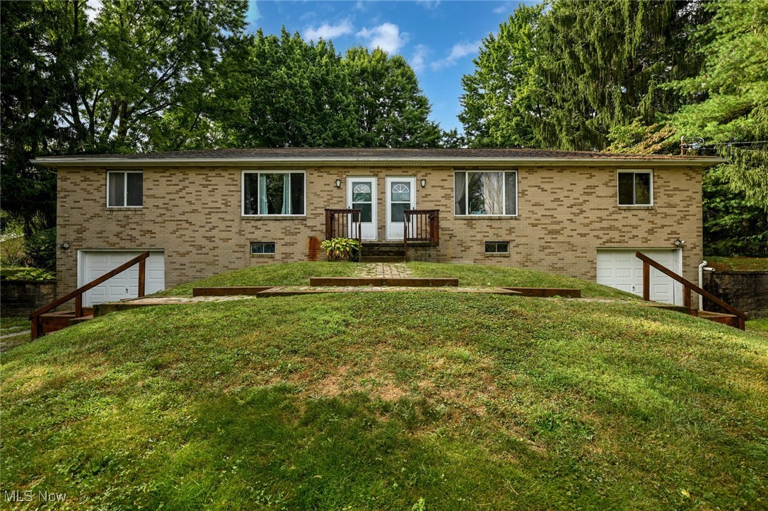 Awesome Opportunity Alert: Mogodore/Portage County all-brick duplex on 1.4 beautiful and private acres in God's country. This is a fantastically cared-for 2-unit building, each with two bedrooms, updated bathrooms, updated eat-in kitchens, and private basements featuring storage and a laundry room on each side. Both sides have a garage underneath accessible from the basement. The extra-large backyard is partially treed and very private. The front yard is nearly as private simply due to the rural nature of the surroundings. Each unit has built-in stairs and walkways leading to its respective front doors. This rarity is wonderfully cared for, inexpensive to maintain, is rural enough to make it very desirable, but close enough to remain convenient, and comes equipped with long-term (3 years and 5 years) quality tenants with month-to-month leases, and the ability to increase the net income considerably. New well pump last year (2024), some newer appliances, new furnaces in 2021 (converted from oil to gas), and newer hot water tanks. Well & septic in great shape. Tenants pay all utilities. Trash is privately contracted and up to the tenant to choose a provider. Owner pays for lawncare and maintenance. Field Schools. You can't go wrong on this one. Tell your mama, tell your friends, to call their favorite Realtor today and arrange to view this beauty while you still can!