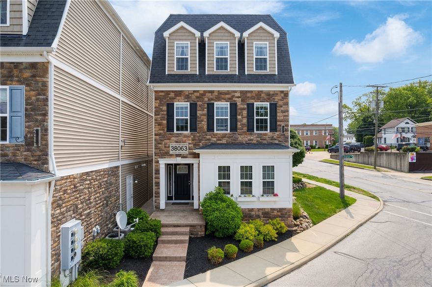 Located in the heart of Downtown Willoughby, this bright and airy townhome offers high ceilings, a sprawling floorplan, and convenient location. With easy access to the area’s renowned restaurants and bars, this residence places you in the center of it all! 
The entry is on the garage level, where an elevator provides access to both upper levels - ideal for ease and accessibility.
Inside, you’ll find a spacious living room filled with natural light, a cozy fireplace, and many windows. 
Glass, French doors open to the handsome office, featuring elegant wainscoting and wall of custom built-in shelving and storage - perfect for working from home or creative pursuits. 
The family room offers flexibility and could also be used as a formal dining space.
Prepare culinary delights in the gourmet kitchen, designed for both function and style, with an expansive center island/breakfast bar, granite countertops, trendy tile backsplash, extensive cabinetry, and stainless steel appliances. A bright dining area off the kitchen leads to a large balcony porch that spans the length of the home—ideal for entertaining or relaxing outdoors.
A convenient half bathroom completes the main level.
Upstairs, retreat to the owner’s suite which boasts abundant windows, a walk-in closet, and a luxurious ensuite bathroom with double sinks and a walk-in shower. 
Two additional bedrooms (one with its own walk-in closet), a full bathroom, and a laundry room complete the second level.
Additional highlights include a brand-new garage door on the attached two-car garage (June 2025). 
Don’t miss the opportunity to own this fabulous, move-in ready townhouse in one of Willoughby’s most vibrant neighborhoods!