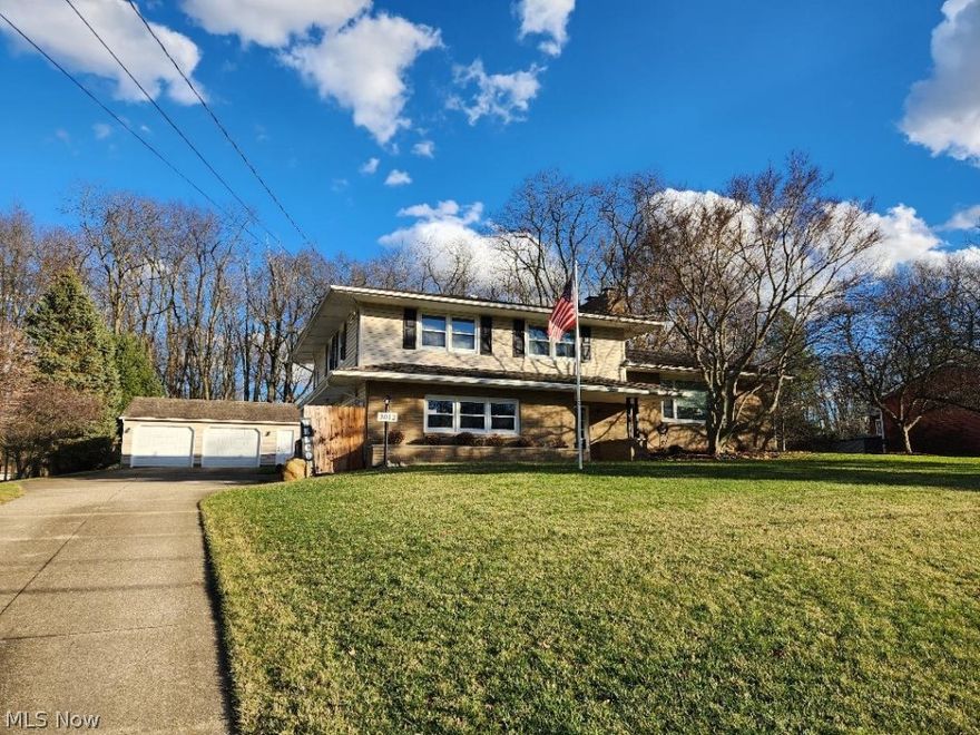 Beautiful custom split level home in desirable Brimfield neighborhood, right next to Mogadore Reservoir. Partially wooded lot on a dead end street with a fully fenced backyard and easy to maintain koi pond with waterfall. Three large bedrooms, master with walk-in closet and en suite bathroom. Second full bath is upstairs, half bath on entry floor. Custom chef kitchen with six burner gas stove, quartz surfaces and custom cabinets - fully remodeled in 2017. Stunning floor to ceiling stone wood burning fireplace. Large and open living areas. This home has been immaculately maintained with too many extras to list. Attached heated two car garage; detached 32X28 heated garage and workshop. Concrete driveway and maintained perennial flower beds. Custom concrete patio. All appliances are included.