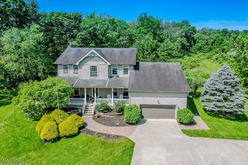 Dreaming of country living? This 4 bedroom, 3 full bath home sits on a scenic 5 acre lot with manicured landscaping, a wraparound porch, and quality finishes throughout. Completely renovated, it features hand-scraped hickory hardwood floors, solid wood doors, and crown molding that speak to the craftsmanship found in every room. The living room includes a stone fireplace and opens to the eat-in kitchen with custom hickory cabinetry, granite countertops, and KitchenAid appliances. A full-size dinette is great for everyday meals, while the formal dining room is ideal for special gatherings. A spacious laundry room and full bath complete the main level.
Upstairs, the primary suite feels like a retreat with a walk-in closet and spa-style bath that includes a jetted tub, glass-enclosed shower, and double sink vanity. Three additional bedrooms, all with ceiling fans and large closets, share a beautifully finished bath with a tile step-in shower.
The finished lower level adds flexible space for a rec room, workout area, and a bonus room perfect for a home office or hobby space, along with easy access to the attached 2 car garage. It's also rough plumbed for a full bath, offering even more potential.
Additional features include a whole house generator, reverse osmosis system, and 200 amp electric service. Outside, enjoy peaceful backyard views from the deck, with mature trees, space for a garden, and room for kids or pets to roam.
Located in Northwest schools, this private setting is one you won’t want to miss. Schedule your showing today!