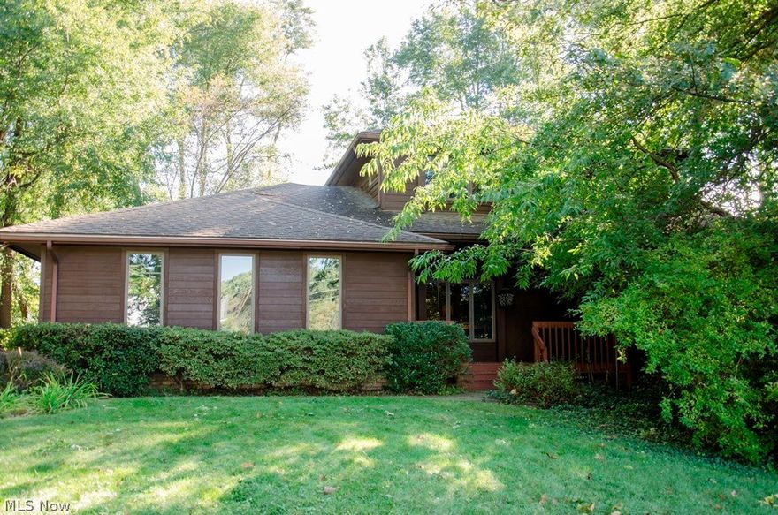 This park-like setting alone elevates this home from ordinary to EXTRAORDINARY. A private, partially wooded acre of land, nestled on a cul de sac, in one of the highest rated school systems in the state, is an amazing find, even without throwing in a 4,300 sq ft, 5 BR/3.5 BA home! This custom built home features a total of 4,360 sq feet, including the beautifully finished, walkout lower level. Additional amenities include a 3 car garage, with hot/cold running water, geothermal zoned heating system with central air, all kitchen appliances in the large, open kitchen, newer 80 gal hot water heater, phenomenal solarium, vaulted ceilings, open floor plan, heated floors in the walk out lower level with wine room, plus a possible in law suite. The kitchen boasts newer appliances, granite counters and ceramic tiled back splash. The flooring throughout is a mixture of hard wood, carpet, ceramic and vinyl. This home also features a large master suite with new carpet and 2 large closets and full