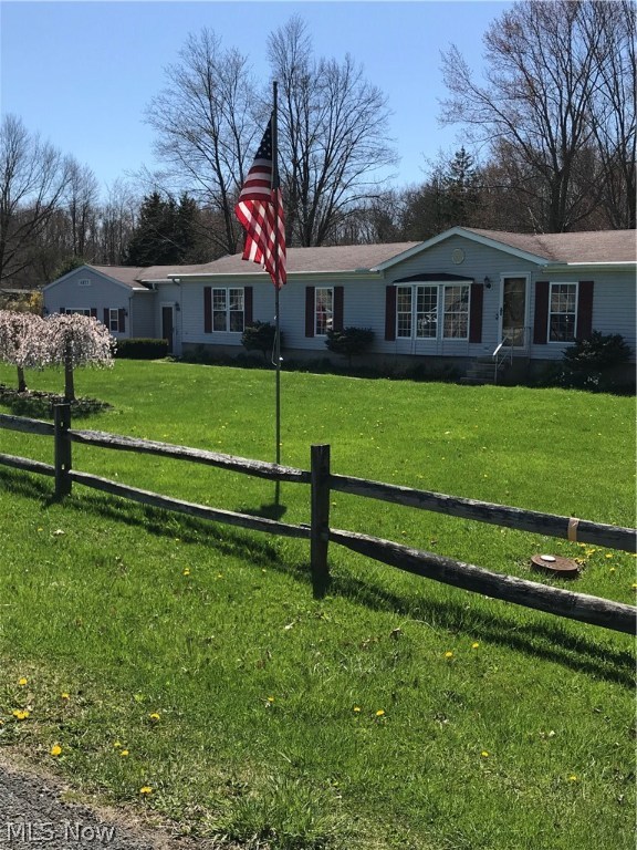 This Lovely Ranch has room for everyone! As you walk in the front door you will see the spacious living room with a bay window. There is a dining room area as well. The spacious eat in kitchen is fully applianced, with a sliding door to the deck. There is a family room off of the kitchen for your convenience. The master bedroom connects to the updated master bath with double sinks and a walk in shower and closet. There is an addition which adds privacy for two more bedrooms and extra storage. There is an oversized two car garage with a rear entrance. There are two outbuilding for storage or a work area. New plumbing and water filter in 2013. There is some new hardwood flooring. Six ceiling fans. New furnace in 2011. This home has 4 parcels that total almost an acre. Situated in Rootstown with Rootstown schools.
