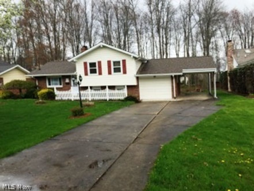 3 bedroom brick and vinyl split level with 3 fireplaces, eat in kitchen.  Family room with stone fireplace and gas logs, Second family room on lower level with bar, stone fireplace and knotty pine, 2 full baths, central air, attached garage with carport.  Hardwood floors throughout, family room opens to cement patio. Wooded backyard, private street.  Priced to sell!