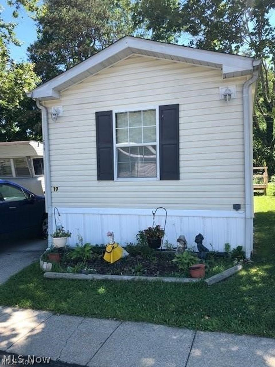 Back on market due to management non-approval. Nicely maintained home in the hidden community of Stow Estates! Tired of lots of yard care? This spacious home might be the perfect match for you! The mobile home is a 2004 model and has had some recent updates! Since 2015, the owner added an awning, a hot water tank in 2016, new water lines in 2016, and laminate flooring. The home has a nice deck and a storage shed which will stay. Seller is leaving all the appliances as well! One of the bedrooms has it's own private half bath. The monthly maintenance fee is for lot rent and this fee also takes care of trash removal. There is a children's park, a basketball court and a dedicated pet area in this community.