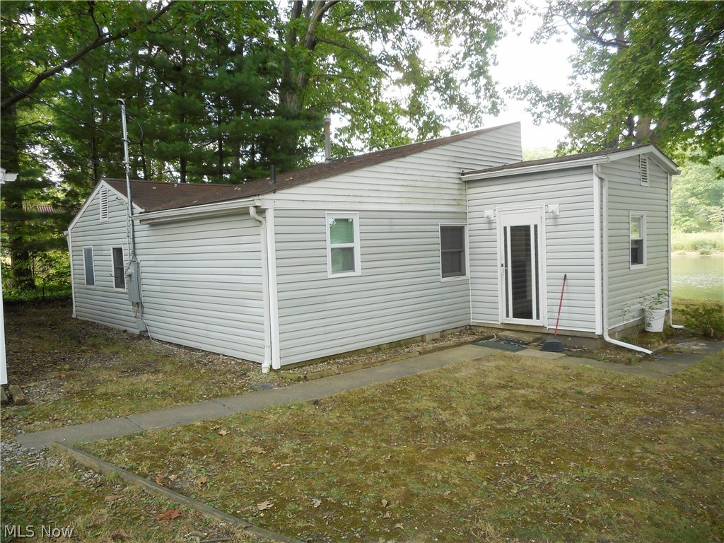 Enjoy fishing and boating from your own backyard! Located on Meadowbrook Lake this 3 bedroom ranch offers a sun room with sliding doors to the yard, allowing for lots of natural light, great views and access to the lake. The exterior has been updated with vinyl siding, french drains and a newer garage door. Inside you will find an updated bath, newer service panel and a spacious kitchen accented by a brick fireplace and laminate wood floors. This home includes 2 lots and will be "sold as is".