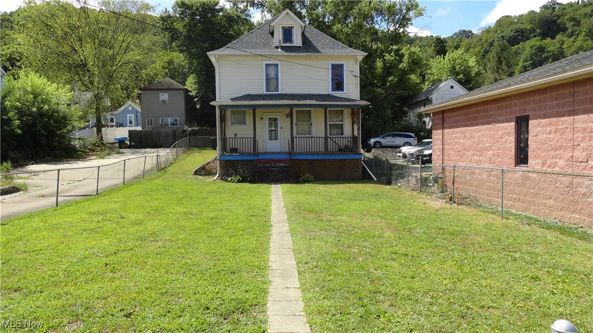 Large 3 bedroom home with large fenced FLAT yard on main street through town. Large front porch to enjoy the parades and fireworks. Home sits towards rear of lot, so it has a huge front yard completely fenced with chain link. Parking on street or in alley. Family home that has seen lots of love and memories, now ready for you to add your personal touches and start making NEW memories. Conveniently located to restaurants and shopping. Per seller new roof in less than the last 10 years.