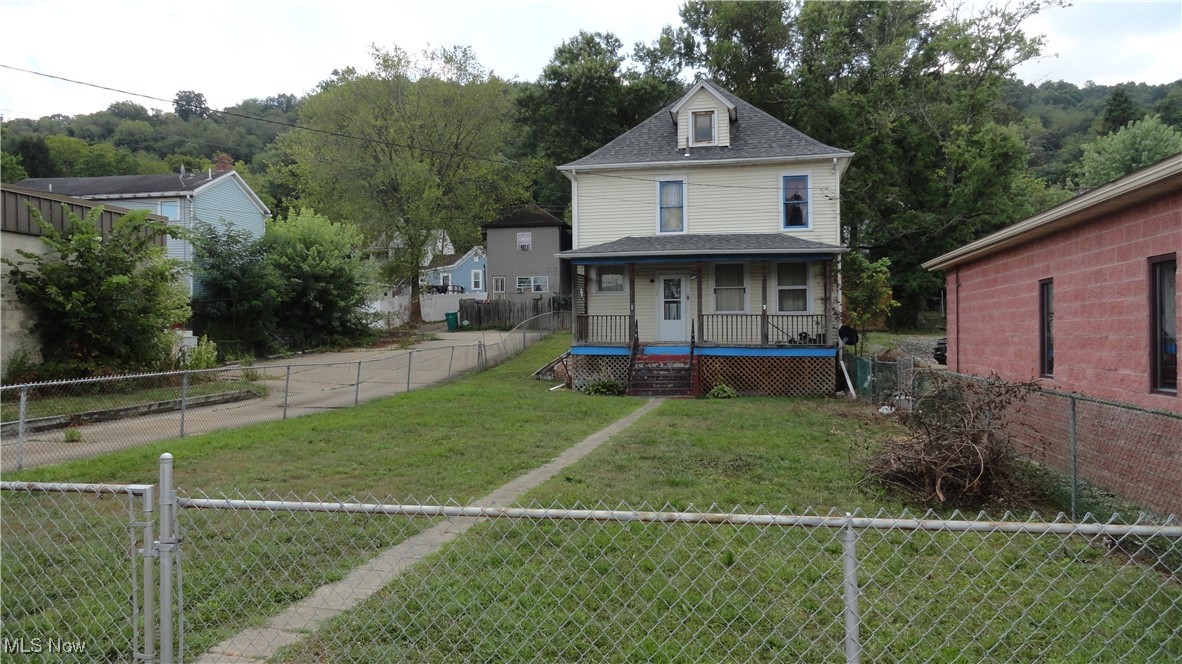 Large 3 bedroom home with large fenced FLAT yard on main street through town. Large front porch to enjoy the parades and fireworks. Home sits towards rear of lot, so it has a huge front yard completely fenced with chain link. Parking on street or in alley. Family home that has seen lots of love and memories, now ready for you to add your personal touches and start making NEW memories. Conveniently located to restaurants and shopping. Per seller new roof in less than the last 10 years.