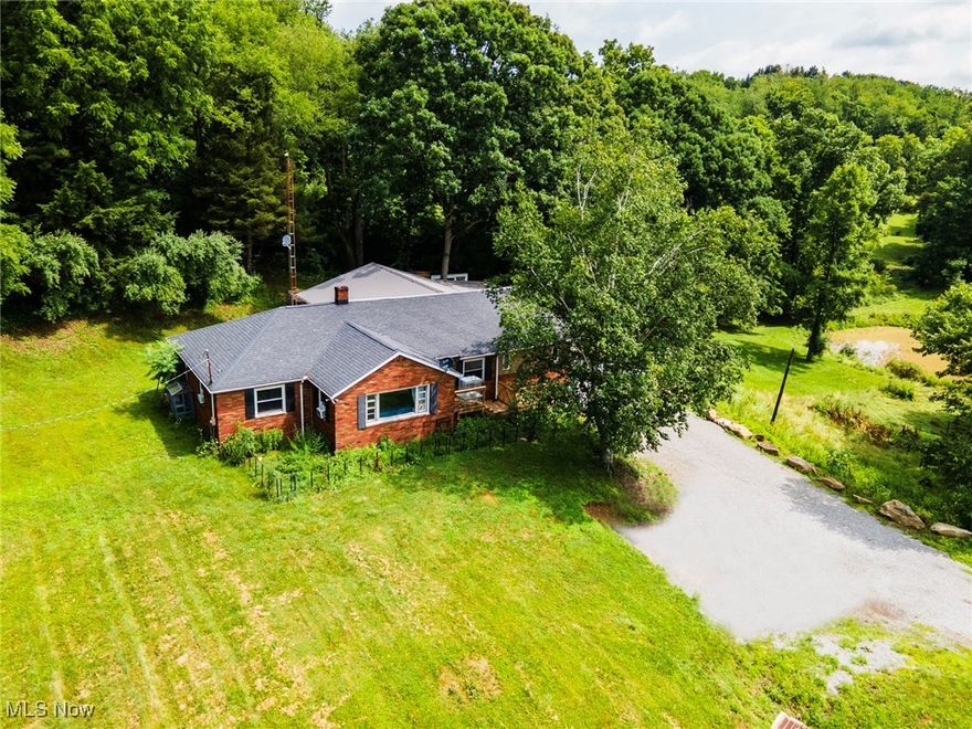 Brick Raised Ranch with In-Law Suite on 3 Acres – United Local School District Nestled on 3 peaceful acres in the United Local School District, this brick raised ranch offers a welcoming blend of comfort, space, and thoughtful updates, all wrapped into a layout that suits a wide range of living needs. The main home features 3 bedrooms and a remodeled, freshly painted full bath. A large, light-filled living room invites you in with its charming bay window, and the dining area just off the kitchen creates an easy flow for everyday living. In 2024, a beautifully designed in-law suite was added—creating a space that feels both private and naturally connected to the main home. It features a vaulted-ceiling sunroom overlooking the backyard and koi pond, currently used as a combined living and sleeping area. The brand-new kitchen includes sliding glass doors that open to an oversized covered deck—perfect for quiet mornings, relaxed evenings, or gathering with loved ones. A full bath with a walk-in shower adds a soothing, spa-like touch. You’ll also find a private bedroom with a cozy fireplace and deck access, along with convenient first-floor laundry. Downstairs, the full basement offers even more potential, with a partially finished space, a full bath, and a 1-car garage—all supported by a solid concrete block foundation. Outside, the property invites you to enjoy the oversized yard, mature trees, and a powered 32' x 43' cemented floor barn with upstairs loft near the koi pond—ideal for storage, hobbies, or simply a peaceful retreat. Also included is a 12' x 8' chicken coop with a 8x15 covered run and a 6x8 stall with fenced turn out for goats. Major updates within the last year include new HVAC, central air, a hot water tank, and two upgraded electrical panels—providing comfort and peace of mind for years ahead. This versatile home gives you room to spread out, grow, or simply savor the quiet beauty of the countryside.