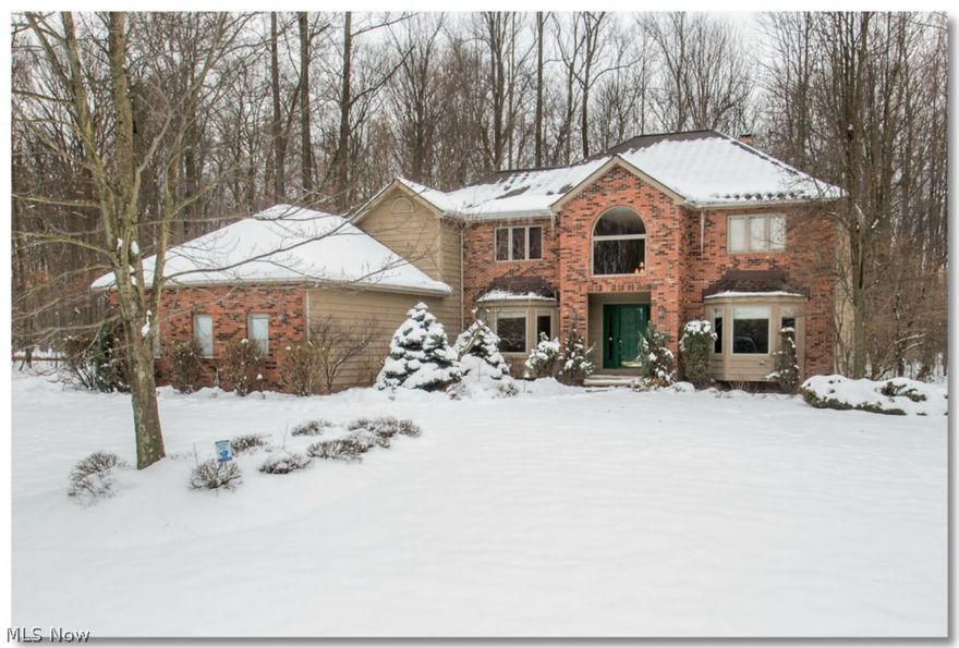 Prime North Solon location! Quality construction, brick and cedar colonial adjacent to Metropark! Many recent improvements! Family room with vaulted ceiling, wet bar and stunning stone fireplace. Two story entry. Library with built-ins and full bath! Hardwood in living room, dining room and foyer. Fabulous white kitchen with center island and cooktop! Bay window in breakfast room and living and dining room. Huge master suite, limestone in master bath with jetted tub and seamless shower door. Dressing room with 2 walk-ins! Ample bedrooms, main bath with dual sink and granite. Fabulous lower level plus wine cellar! Two furnaces and one air conditioner-all newer.