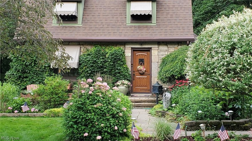 This 1930's Cape Cod style home is accented with English gardens in a charming neighborhood with close proximity to historic district Olmsted Falls Schools, Cleveland airport and I-480.  The home has been updated while maintaining the character and details original to the home.  Hardwood floors, wood ceiling beams, sandstone carved fireplace, pella windows, updated cabinets and stainless steel appliances.  First floor bathroom updated with tile shower.  Fenced rear yard, potting shed and a over sized barn style 2 car garage.