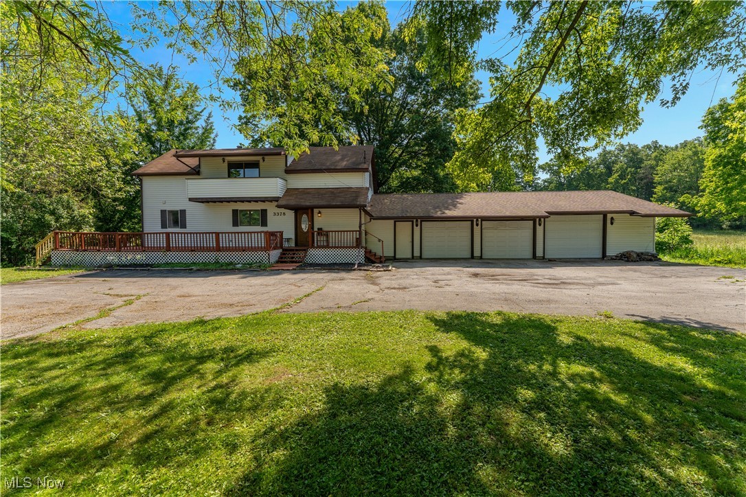This unique one of a kind home located within Crestview School District offers a country setting within 5 miles to historic Village of Columbiana. With 4 bedroom 2 baths it provides plenty of room for all of your needs. 2nd floor landing has sliding doors to balcony. Primary bedroom located on first floor. 3 additional bedrooms on 2nd including a full bath with 2 access doors, Custom woodwork throughout. Large kitchen with booth seating. All appliances stay for your convenience. Dining room open to living room along with sliding doors with access to deck. Basement provides additional living space with yet another set if sliding doors that open to backyard. Circular driveway with HUGE 3+ car garage 3rd garage with through and through access includes workbench and cabinetry. Porch wraps around home large back deck partially covered. You will have no lack of storage in this home.