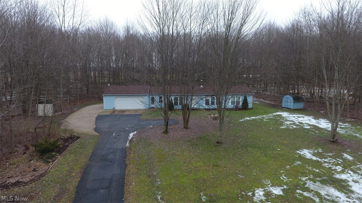 Who's looking for peace and quiet? This is like your own private retreat! Fantastic wooded setting! This home sits approx. 300 feet off the road! Nicely paved driveway leads to this 1995 ranch style home located on 1.89 acres! Newer roof, furnace and central air in 2015-2016! Oversized 24x24, two car attached garage leads to the family rm/den with newer carpet! Freshly painted walls really brightens up each room! This kitchen is simply amazing! It has dining area with a large picture window that overlooks the wooded rear yard! Tons of counter and cabinet space with a huge wall pantry! All kitchen appliances stay! This home has natural gas but the wood burner in the living room does a fantastic job of heating this home! Each bedroom has a large walk-in closet and ceiling fan! There is a approx. a 4 foot crawl space under the home. Store your lawn mower in the large shed and your extra wood for the wood burner in the homemade lean-to! This home really does have it all! IMMEDIATE occupanc
