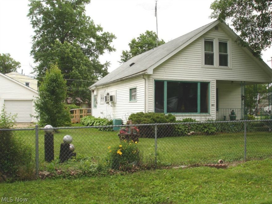 ~Unique Cottage Near the Lake~  Multi-generational family home being sold because owner can no longer live alone.  On three parcels, the property includes the home with fenced yard, two car garage, and shed.  The home offers very spacious living room and master bedroom along with an eat-in kitchen, dressing room, bath, and laundry room all on one floor.  Two gas heaters and a window AC unit are included.  A unique counter weighted staircase drops down into the dressing room for access to two finished attic rooms. In a lovely neighborhood of nicely kept properties, this home needs a new owner who will update and remodel it to bring it back up to its potential.