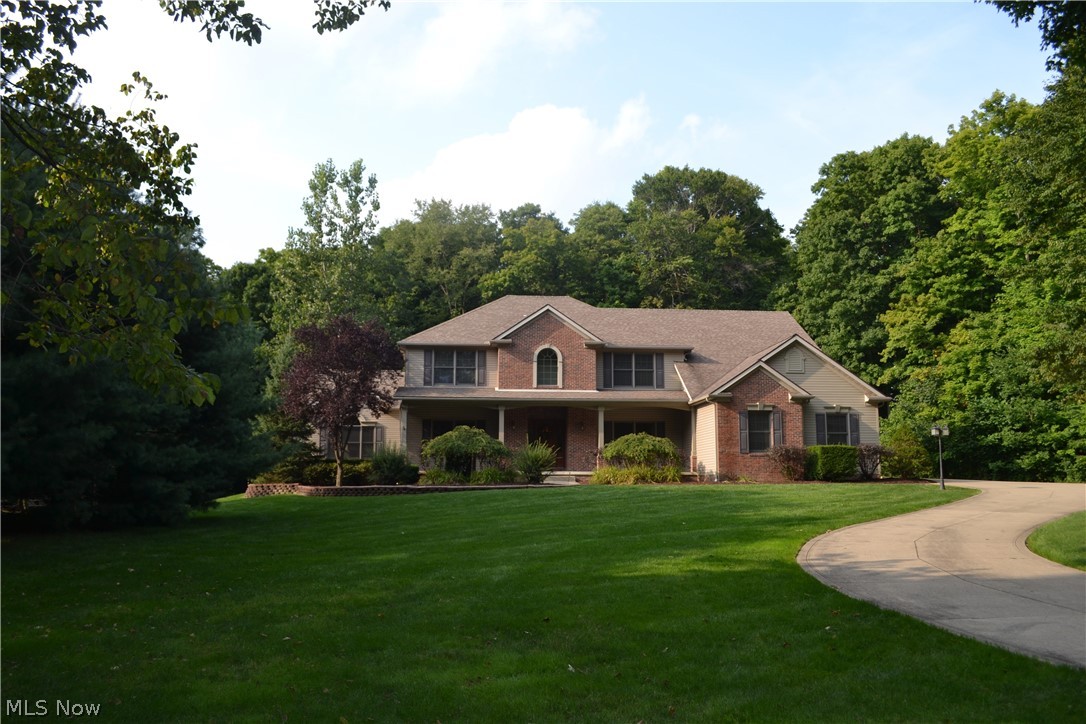 Gorgeous custom designed home located on a private cul-de-sac. Yard work is minimal with the natural 2+ acre wooded setting. Oversized covered porch leads into a welcoming 2-story foyer with hardwood floors, vaulted, step down great room with fireplace, large newly renovated eat-in kitchen with outdoor access, new granite in Sept. 2018, cherry cabinets, large center island, breakfast bar, work station, and walk-in pantry. Open-concept formal dining room with French doors, living room with crown molding. Additional bedroom on first floor with full bath access is ideal for in-law or private guest bedroom. Custom lighting and neutral colors throughout. Second level offers spacious master bedroom with 13 by 11 sitting room; ideal for office or infant room, 2 large walk-in closets and glamour bath with double vanity, skylight, garden tub and separate shower and commode. Second floor also includes 3 additional bedrooms, all with large walk-in closets and a shared full bath. First floor