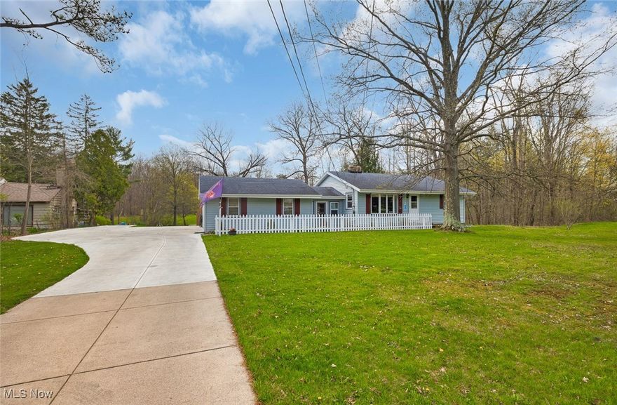 Welcome to 17027 W 130th Street in North Royalton, a welcoming Ranch nestled on a picturesque 1.75 acre property. Perfectly blending comfort and outdoor beauty, this home offers an inviting living room featuring a bright bay window, wood floors, and a cozy stone fireplace, flowing seamlessly into the dining area with built-in shelving. The kitchen is outfitted with plentiful wood cabinets, updated countertops (2015), and included appliances. Two comfortable bedrooms, both with wood floors, ceiling fans, and nice closet space, offer restful retreats, while a full bathroom with a brand-new shower (2022) and a convenient mudroom/breezeway complete the main level. The finished basement expands the living space, offering a recreation room with updated carpeting (2022), a 2nd fireplace & a wet bar perfect for gatherings, a full bathroom with shower (2018), a laundry room, access door outside, and plenty of storage. Outside, the property truly shines with a spacious deck, a fenced-in area ideal for children and pets to play, and a stunning backyard complete with a barn; a rare find offering endless possibilities. Additional updates include a new garage door(2022), a brand-new driveway (August 2024), a new front door and gutters (2023), and newer furnace and A/C systems (2022); Exterior of house to be fully repainted dark grey before closing plus a 1 year home warranty is provided. Located in North Royalton, you’ll love the convenience of nearby parks, schools, shopping, dining, and easy access to major highways. This comfortable home with land, a barn, and modern updates is a unique opportunity you won't want to miss.