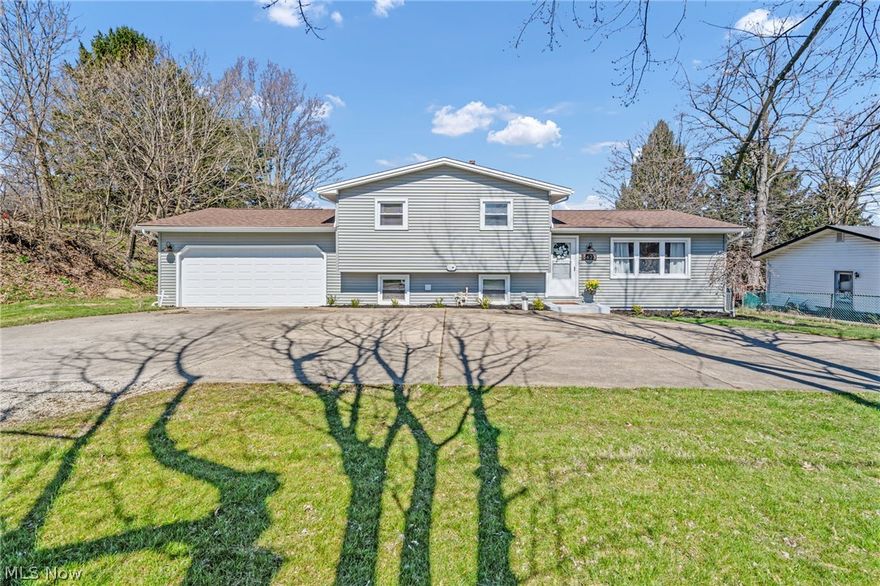 Welcome home to 5623 Navarre Rd SW, located in Perry LSD. This split level style home has 3 bedrooms, 1 bathroom, and a backyard full of opportunity. When you walk through the front door you’re instantly greeted with cathedral ceilings lined of solid wood, such a statement! The kitchen features brand new flooring and refreshed cabinets/counters. The first level is complete with a great sized dining space and sliding door the gorgeous half acre fenced in backyard. Upstairs you’ll find all 3 bedrooms and a newly updated full bathroom. The lower level is HUGE and has a fireplace, plus lots of space for entertaining. Off of the 2 car garage is a 14x14 storage room that is easily accessible. There is no shortage of updates outside either; the entire home has brand new siding, downspouts, and gutters. Along with a new garage door and garage door opener. This property is not far from the highway and close to all your local amenities. Call your favorite Realtor® today to schedule a private showing.