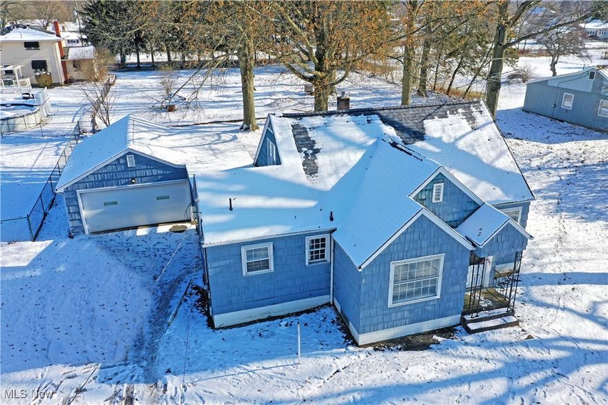 The only winter blues you’ll find here are the within the bold exterior colors that stand out against the fresh fallen snow! Welcome home to quiet Girard where you’ll find this masterfully remodeled home and its three floors of must-see living space. Celebrate in style as you explore the brightly lit rooms, filled with large, lattice windows and elegant overhead lighting choices. From the outside in, the engaging exterior continues to present a two-car garage, attached via a covered walkway that extends into a shielded patio space. Inside, sculpted archway begins with the foyer and transitions from the sun washed living room before continuing into nearby casual dining or parlor space and its picturesque front yard views. A daring kitchen brings polished stone countertops with elegant marbling that pair with a rich, green backsplash. Formal dining enjoys built-in corner cabinetry. Meanwhile, the first floor is completed by a pair of spacious and inviting bedrooms as they accompany a stylish full bath, brimming with sleek tile work. Upstairs, a third, loft style bedroom enjoys hardwood flooring. At the basement level, finished rec space is abundant while hidden utilities and second, full lower bath provisions are available.