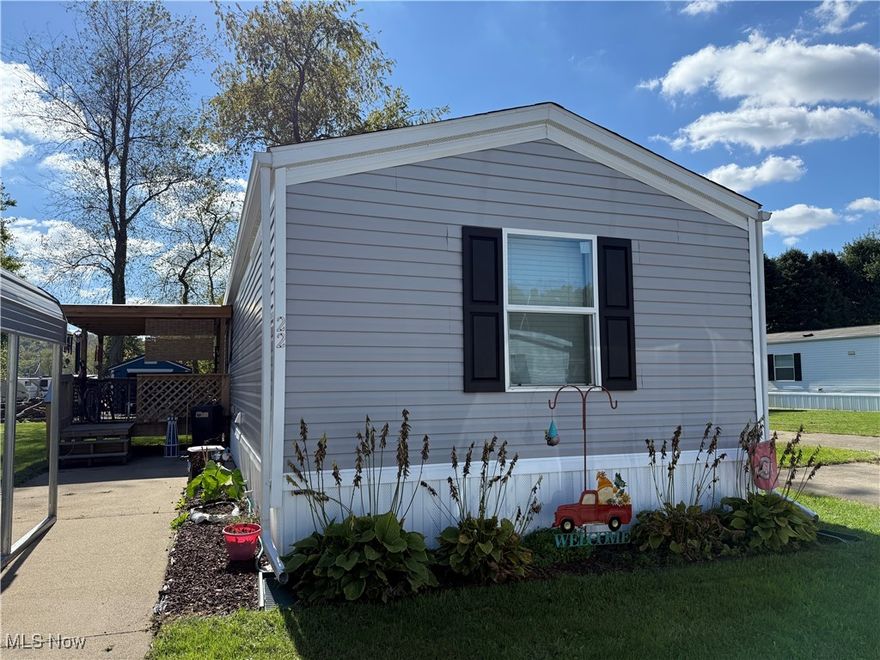 Only 4 years old! 3 bedroom, 2 full bath 2021 Clayton mobile home with a covered porch and 2 car carport.