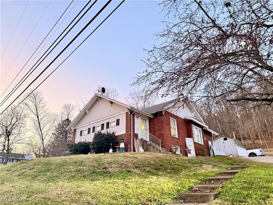 Enjoy peaceful country living with this well-kept brick home on just over 3 acres. The home features 2 bedrooms with a possible third, a spacious kitchen with tons of cabinet space, and a comfortable, flexible layout. Outside, the property offers multiple outbuildings perfect for animals and a detached 3-car garage/workshop ideal for projects, storage, or hobbies. A great opportunity for anyone seeking land, privacy, and room to grow. Schedule your showing today!