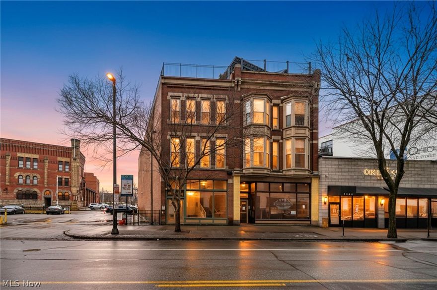 1148 Prospect Ave. E – Unit A
Historic Presence. Modern Precision. Front-Row Downtown Living.

Welcome to Joshua Hall, where 19th-century craftsmanship meets the pulse of downtown Cleveland. Perfectly positioned between Playhouse Square and the Gateway District, Unit A offers a rare opportunity to own an architectural residence in the heart of it all.

From the moment you enter, the scale makes a statement—towering ceilings, floor-to-ceiling exposed brick, and dramatic bay windows overlooking Prospect Avenue. This isn’t a typical condo. It’s a home with presence.

The open living space blends historic character with thoughtful modern updates. Natural light pours through oversized windows, illuminating freshly cleaned brick and ceilings that allow the building’s original craftsmanship to shine. The kitchen anchors the space beautifully and now features a brand-new dishwasher and a reverse osmosis water system.

The improvements here are meaningful: air ducts and washer vent professionally cleaned, new AC, new water heater, sealed roof, restored leaded glass panes, and new wood flooring in the bedroom. These updates enhance comfort while preserving the integrity of the building’s historic bones.

And then there are the rare downtown luxuries — two private covered parking spaces and a full private rooftop deck offering stunning views of Terminal Tower and the historic Cleveland Armory. Whether enjoying a quiet morning coffee or hosting friends under the city lights, this rooftop retreat elevates the entire experience.

Joshua Hall offers what new construction cannot replicate—authentic materials, timeless proportions, and enduring architectural detail.

Step outside and you’re moments from Playhouse Square, Progressive Field, Rocket Arena, and Cleveland’s best dining and nightlife. Dinner before the show. A quick walk home. City living at its most refined.

Historic soul. Modern systems. Exceptional amenities.

Downtown living—elevated.