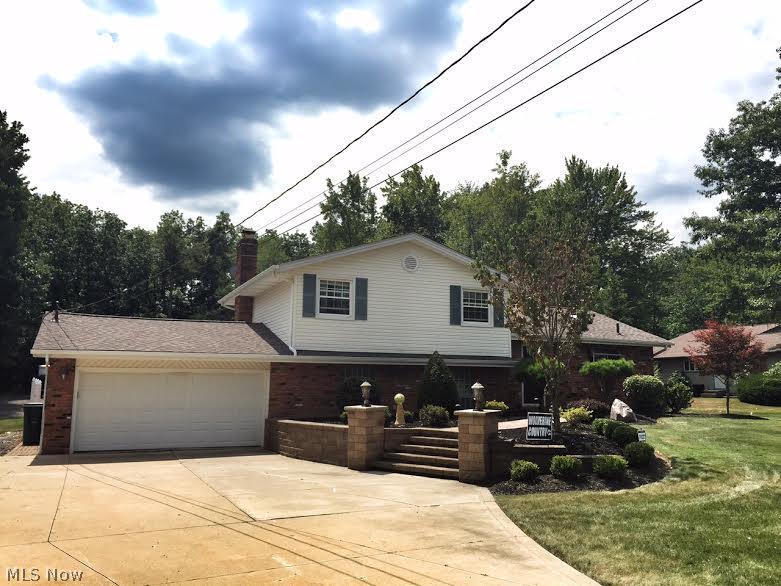 Meticulously maintained Chesterland split level with 2,200 square feet of living space on 1.5 acres! Walk into the expansive kitchen and enjoy the beautiful granite counter tops, stainless steel appliances and all the counter top and cabinet space you will ever need! Three season room just off the kitchen with wonderful views of the beautifully landscaped yard and a patio made to entertain! 30'x30' great room with a wall of windows to let in all the natural sunlight! Vaulted ceilings! The great room has sliders to the private, second patio. Three bedrooms up with full bath! Half bath and large utility room just off the great room. Check out the yard! Deep lot with a heated outbuilding that would be perfect for a dream workshop! Put this on your list because you will want to see this house!