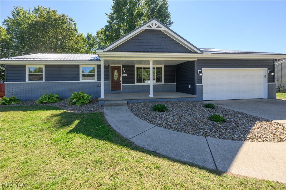 Welcome home to 3012 Shellhart Rd. in Norton. Move in just in time to celebrate the holidays in your new home. You will love cooking and entertaining in the Amish built kitchen with Quartz countertops, tile backsplash, stainless steel appliances and soft close cabinets. Kitchen opens to Family room with electric fireplace. Living room and the three bedrooms have gorgeous oak hardwood floors that have been refinished. Full bath with garden tub and stand alone shower and double sink vanity. Partially finished walkout basement can be finished for additional living space. Glass block basement windows. 2 Car attached garage. New metal roof - 2023; Trex deck with steps, railing and skirting - 2024; vinyl siding and shakes - 2023; Oversized gutters and downspouts - 2023; All new interior doors - 2023; Custom front door, Window World Windows - 2023. See list for complete details of the $135,000 invested in this wonderful ranch home.