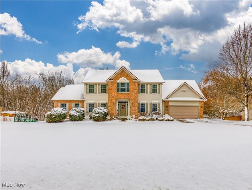 Welcome to this stunning Colonial-style home in Cuyahoga Falls, featuring 4 spacious bedrooms, 3.5 baths, and 2,661 sq. ft. of above-grade living space, plus an additional 1,098 sq. ft. in the fully finished walk out lower level. Step inside to a thoughtfully designed layout that’s perfect for both entertaining and everyday living. The main level showcases a formal dining room accented with a tray ceiling and crown molding. Across the foyer, you’ll find a versatile home office, currently being used as a playroom. The main level also features a spacious great room with a gas fireplace, cathedral ceilings, and an abundance of natural light. Just off the great room, the space seamlessly flows into the eat-in kitchen, offering a large dining area, a center island, stainless steel appliances, and abundant storage. The kitchen opens to a back deck that offers peaceful views of the backyard and the wooded setting that borders the property, creating a private and serene outdoor retreat. A convenient half bath and laundry room complete the main level. Upstairs, the primary suite features vaulted ceilings, a walk-in closet, and a spacious ensuite bath complete with a second walk-in closet, a soaking tub, a walk-in shower, and his and hers vanities. Three additional bedrooms and a shared full bath complete the second level. The fully finished walk-out lower level offers a spacious rec room with a full bath, a large storage room with built-in shelving, a separate utility room, and direct access to the back patio. Updates include: New Furnace with Humidifier (2024), New A/C (2024), and Tankless Water Heater (2022). Don’t miss the chance to make this beautiful Cuyahoga Falls home yours! Ideally situated near the Portage Crossing shopping district, Cuyahoga Valley National Park, and a variety of dining and entertainment options.