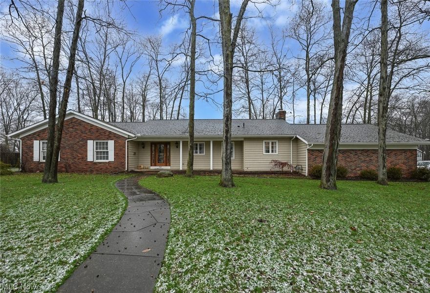 Welcome to Forest Meadows in Medina!  This lovely development is in close proximity to Medina High School, the Medina Recreation Center, and minutes from Medina's charming historic square.  This handsome spacious ranch is nestled on a desirable treed lot and boasts a covered30 x4  front porch and an oversized two car, side entry garage. You will love welcoming guests through the beautiful leaded glass front door. The inviting foyer opens to the spacious common areas including the large living room, which is adjacent to the dining room. The centrally located and well-planned kitchen is also accessed from the foyer and includes all appliances, an eating area, and a convenient planning desk. The eating area of the kitchen is open to the wonderful family room, featuring a brick woodburning fireplace with gas start. You will also love the built-in bookcase, wood flooring, open staircase to the full basement, and direct access to the enormous sun room, overlooking the backyard. The enclosed sunroom is the length of the home with sliding doors to family room and dining room.  There are three generous bedrooms with the primary bedroom offering two walk-in closets and an ensuite full bathroom. An additional full bath is located in the hallway and a half bath is conveniently located off of the laundry room. The roomy laundry features a laundry tub, cabinetry, a large closetand a window. Many updates were made by the previous owners in the 2000's including the kitchen, exterior siding, gutters and electrical panel box. Recent updates include the air conditioner (2023) and hot water tank (2020).