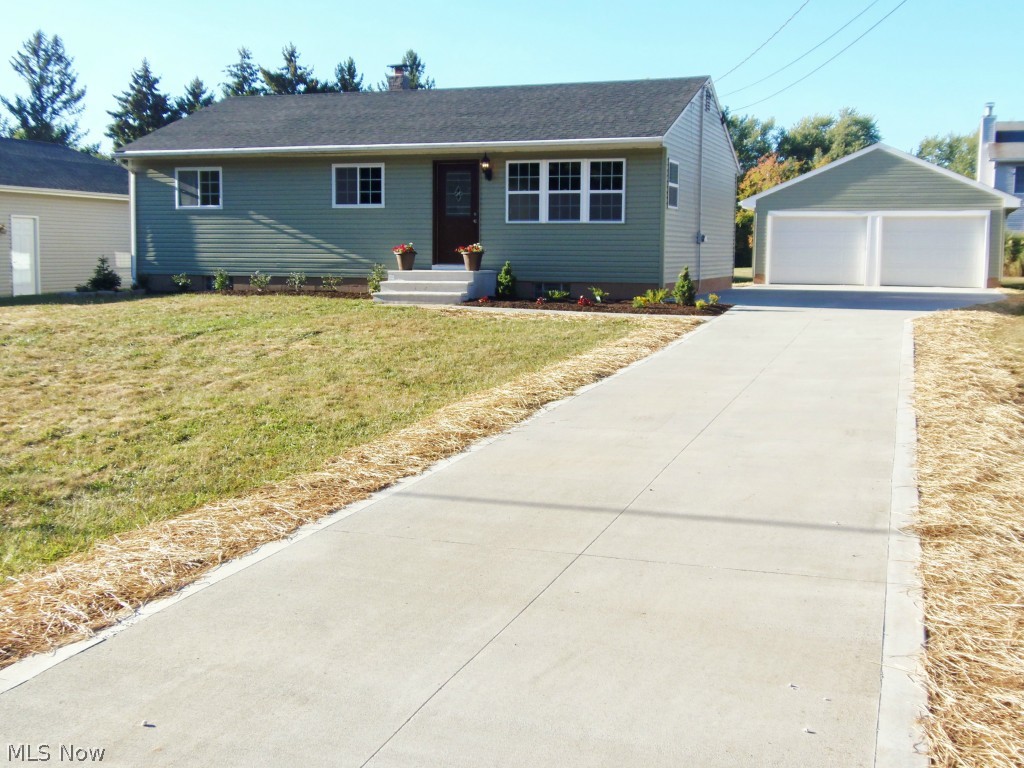 Practically a New Home. Everything New in 2015 including roof(35 year 3 dimensional shingle) gutters and downspouts,, vinyl siding, windows (vinyl double paned) Cherry Kitchen, Granite counter tops, Tiled glass backsplash, stainless steel range,microwave,refrigerator, wood laminate flooring, remolded bath with ceramic flooring, furnace,Central air,and Hot water tank. Glass block in basement.Also insulated. New concrete Drive,porch, patio and garage floor. New carpet and freshly tastefully painted. All new sidling fans with remotes professionally landscaped.All new interior and exterior doors included the Garage. Check out the new crown moulding through out the entire home. Waterproofed basement. All that since January 2015. Won't last!!