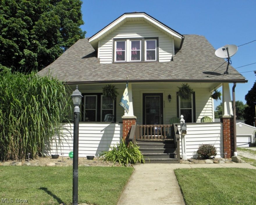 Delightful colonial located in Mogadore features extra lot, unpainted woodwork throughout, and hardwood flooring under the carpet. Front entry of the home features a pleasantly sized porch and gate with plenty of room for entertaining or just sitting to enjoy nice quiet evenings. Living room with built-ins, stone fireplace and arched enteryway into the dining room that features a beautiful hardwood window seat and built-in glass cabinetry.  Large walk through kitchen leads to breakfast nook and patio doors that step onto the back deck with access to the lower level patio and lower level extra lot which is fantastic for all kinds of outdoor activities. 2nd level features a full bathroom, additional hardwood built in linen, 3 bedrooms all with large walk in closets which is a rare find in this style of home. 2 Car garage with electric, storage space and skylight. NEW roof in 2007, NEW hot water tank 2012, NEW windows 2007. Seller to install NEW furnace and central air unit, HOME WARRANTY