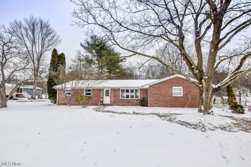 Immaculate all-brick ranch situated on a scenic half acre lot in Plain Local schools! This one-floor living gem features a bright and airy living room with recessed lighting and vinyl plank flooring that seamlessly connects to the adjacent dining room. The beautifully remodeled kitchen is a cook's delight with its breakfast bar, open shelving, ample counter space, deep stainless steel sink, and an adorable coffee bar. Staying connected with family and guests is easy in the adjacent family room, complete with a wood-burning fireplace as the focal point. Sliding doors open to a patio and a tranquil backyard with mature trees and a convenient shed with electricity. The hall leading to the bedrooms reveals a full bath with double sinks and a relaxing jetted tub and shower. The primary bedroom offers a private half bath with a makeup vanity, potentially convertible to a shower. All your storage needs are met in the full basement, housing mechanicals and a laundry area. An added bonus is the 2-car side-load garage. Noteworthy improvements include a new sump pump and an upgraded 200 amp panel with new wiring throughout. Situated in a quiet neighborhood yet close to Oakwood Square amenities, this picture perfect home is the epitome of comfort and convenience. Call to take your tour today!