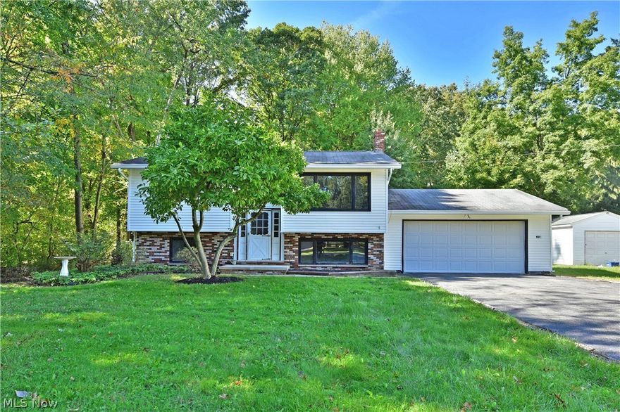 With its prime location and spacious, move-in-ready living space, you won’t want to miss this fantastic four-bedroom Howland Township bi-level! Find yourself in the heart of it all as a beautiful park is just a brisk walk away along with desirable locale restaurants and attractions. Tall trees surround the residence as its partial brick façade creates plenty of curb appeal, outlining the large windows and clean white siding and attached two car garage. A brightly lit, tiled foyer besets a carpeted staircase leading to the main floor. Here a spacious living room takes full advantage of the picture windows, as the sunshine fills the nearby dining room. A corner kitchen is dressed in a faux brick backsplash with warm wooden cabinets that break up the bright white appliances. Around the corner, a fantastic, finished sunroom overlooks the scenic backyard. Opposite, the main hall sweeps past a lovely full bath with glass block accent work as a pair of inviting bedrooms are found at the end o