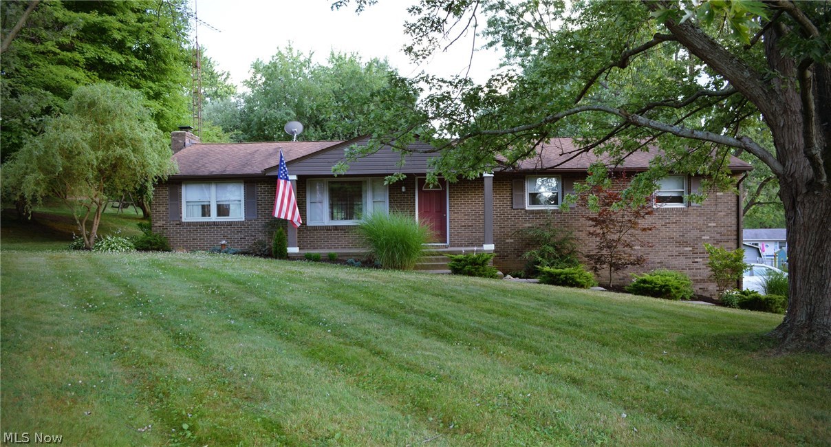 This home is a must see! Nestled on roughly a half acre, this 1,624 sq. ft. 3 bedroom, 2 bath home provides an amazing open floor plan main living space that keeps the family connected. The living room, kitchen and dining areas are all open to each other, giving an open, spacious feel. You will be sure to fall in love with the interior architectural elements and finishing details that this home offers. Fantastic updates have been made throughout this home. The gourmet kitchen has updated cabinets, butcher block countertops, tile backsplash, and a party starter island that is ideal for entertaining. Gorgeous Mannington laminate flooring is present throughout the main living area offering durability for a family with children or four legged friends. The cozy hearth room has a charming wood burning fireplace. The main bath has recently been completely remodeled. The large sunroom features exposed wood beams and leads directly to a huge deck. The private back yard has a fire pit/sitting ar