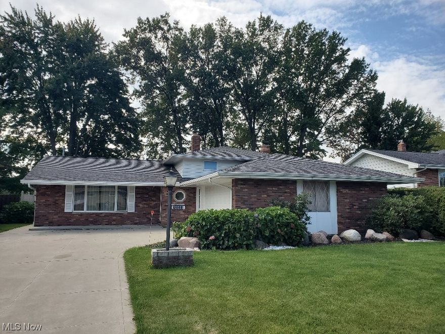 This impeccably maintained family home has been lovingly cared for over 4 decades! Step inside this inviting brick, aluminum split level residence and discover its array of wonderful features. The heart of the home is the custom designed eat-in kitchen, featuring stainless appliances including a gas stove, refrigerator and dishwasher. The tiled living area is spacious with high ceilings that create an open and airy atmosphere. Adjacent you will find a formal dining to entertain with doors leading to the patio. A perfect setting for entertaining and family. With 3 generously sized bedrooms, each boasting ample double closets and beautiful hard wood floors, this ensures that everyone has their own space to retreat to. Upstairs you will find a fully updated bathroom, while the lower level offers a convenient half bath for added convenience. The family room is cozy and practical with a welcoming full stone wall fireplace with insert/woodburner. It opens to a fenced yard, offering a seamless transition between indoor and outdoor living spaces. In addition, the conveniently located laundry room off the family room connects to a two-car attached garage complete with water and electric. Outside the home is a delight with a variety of perennials. This home is ready to welcome you into a warm and inviting embrace!