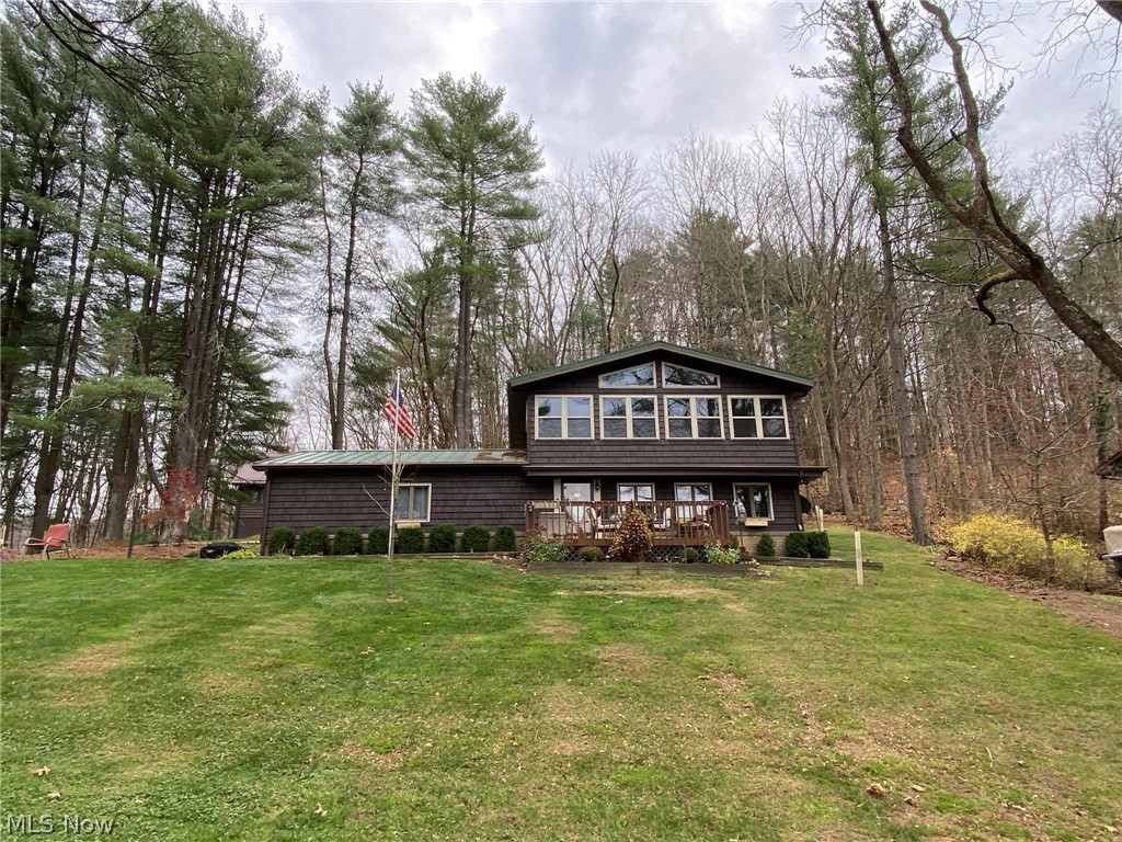 Year round living or a week end get-a-way! A cozy cottage feel greets you as you enter this 3 bedroom, 2 bath home with seasonal views of Tappan Lake. Brick gas fireplace in the living room. White kitchen with stainless steel appliances. First floor laundry room with utility sink. Cathedral ceilings in the second floor glass fronted addition with hardwood floors. Full second floor bath with Granite counters, double sinks, ceramic tile walk in shower, separate tub and walk in closet. Vinyl thermo replacement windows throughout. 2 car attached garage. 6 X 4 storage shed. Mature treed park like setting with new brick firepit. Updated dock in 2018. Updates throughout include second floor addition in 2017, new septic tank in 2018, new pressure tank in 2018, gas logs in fireplace in 2018, replaced gutter and gutter guard in 2020, Generac whole house generator in 2020. Includes golf cart, paddle boat and most furnishings. $108 monthly propane budget for current owner. MWCD leas
