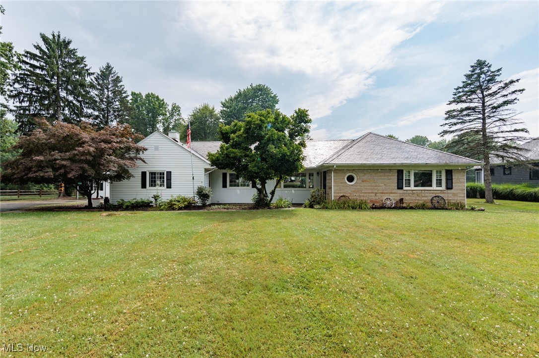 Welcome to this charming 3 bedroom, 2 full bath ranch home in Columbia Station, ideally located within the Strongsville School District. Nestled on two picturesque parcels which includes the scenic Bakers Creek w/ ATV Trails; totaling 3.09 acres, this warm and welcoming home blends the tranquility of country living with the convenience of nearby amenities. Step inside to find lovely woodwork details throughout and an elegant eat-in kitchen featuring granite countertops, abundant wood cabinetry, included appliances, and a cozy dining area. The spacious great room is the heart of the home, boasting 2 large picture window that frames serene views of the private backyard, a striking coffered ceiling, and a fireplace with built-in shelving that adds both charm and functionality. The home offers three comfortable bedrooms and two full bathrooms, including a primary suite with its own private bath. A dedicated laundry area and mudroom add everyday convenience, while the expansive 4 season patio and deck provide the perfect spots to relax and enjoy the natural surroundings. Additional features include an attached heated two-car garage with Nature Stone floor & porcelain sink, a detached one-car garage, and a shed for all your storage needs. Recent updates include a new hot water tank and expansion tank on the boiler furnace, ceiling fans in the living room and kitchen, and refreshed fixtures and paint in the master bath. Bordering Strongsville, this home offers a rare opportunity to enjoy a large property, space & comfort all just minutes from shopping, dining, and more!
