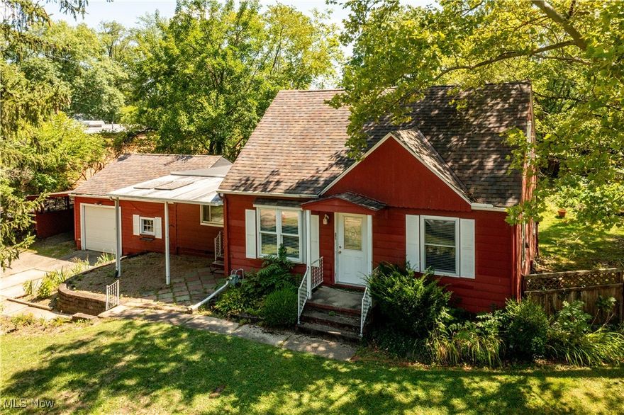 Here is an opportunity to be a homeowner for less than the cost of rent! This Elyria bungalow is looking for its new family.  When walking in the front door, you will be welcomed by the living room with hardwood floors. Look out the front window and have views of the Black River. When walking in the breezeway entrance, you will see the spacious family room with berber carpet. The kitchen offers oak colored cabinets, kitchen island, and stainless steel appliances. Two of the three bedrooms and a full bath are located on the first floor. The front bedroom offers laundry hook-ups, and can be made into a first floor laundry room. Upstairs, there is a spacious third bedroom and a convenient half bath. The backyard is fully fenced and a third of an acre. Enjoy entertaining outdoors on your covered wood deck. Attached to the home is a single car garage with workshop area, and an additional covered carport. Located close to neighborhood schools, highways, shopping, entertainment, and downtown Elyria makes this location ideal. Call for a private showing today!