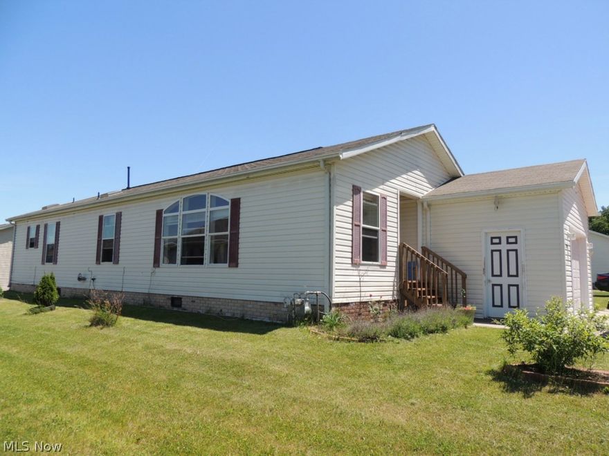 Great Deal Just Waiting for You! Wonderful modern ranch manufactured home built in 2002, with 3 bedroom and 2 full baths located in desirable Lakeside Terrace. Open floor plan, spacious vaulted kitchen w/ long island and breakfast bar,  3 skylights, pantry, lots of cupboards open & airy with eating area. All appliances stay including washer & dryer.  Spacious great room has vaulted ceiling with Paladin window that lets in lots of sunshine.  Sliding doors off kitchen open to fenced deck with gate to the yard.  Master bedroom has  walk in closet. Master bath has linen closet, garden tub, separate shower and sky light. First floor laundry that has door to the deck.  Attached 1 car garage. You will also find strawberries, blackberries and a pear tree in the yard. Minutes to shopping, Turnpike and 480. Leased lot rent paid monthly includes trash removal, common ground maintenance, street snow removal, pool, clubhouse & fishing lake. Land Contract is possible.