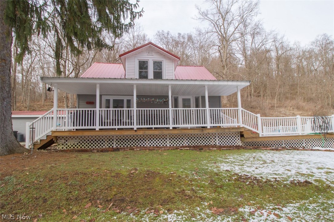Have a yearning for the country? Charming house has privacy with 41.278 acres. Seller recently brought in Belmont County water. Lots of updates as the metal roof, new propane furnace installed by Mountain Aire; which warranty will transfer with 1 year free labor and 5 year parts. Central air unit is a few years old. Has alternate heating for second floor. Entire second floor is the main bedroom with 1/2 bath with composting toilet. Former bedroom on main floor was converted to laundry/child's playroom. Napolene propane gas heater installed in dining room. HWT is leased. Majority of acreage is across street and up the hillside. Parcel #26-1757.000 requires a new survey. Seller will retain mineral rights.