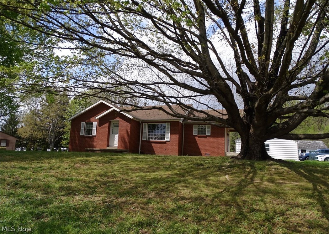 Great piece of property with 3 BR, 2 bath brick home with lots of potential, hardwood floors under current floor coverings in most rooms, full basement with second full bath and blank slate waiting to be finished, 2 car detached garage and an awesome she shed/workshop. Call to view today.