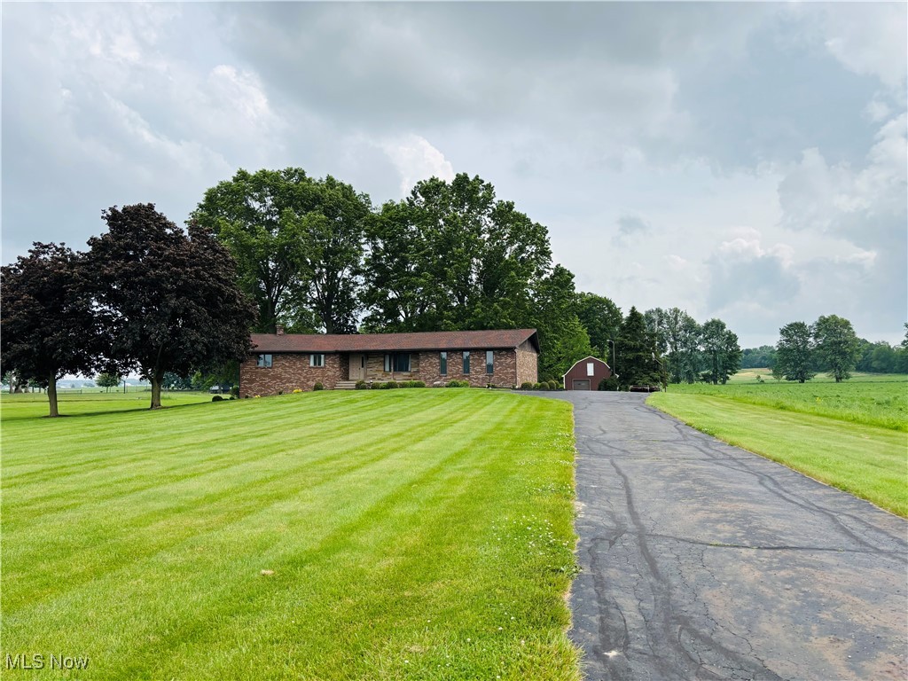 Welcome home to this one owner custom built brick ranch home on 4.11 acres in the heart of Wayne County! This home features a large eat in kitchen with island and built in cabinets and desk, family room with wood burning fireplace, living room, master bedroom with full bath and two additional bedrooms on the first floor. Large laundry room with lots of storage off the attached two car garage entrance plus a screened in porch off the back family room and a rear deck made of composite wood and vinyl railing with a view of the shared pond. The finished basement has a large recreation room with a wood burning fireplace, small kitchen, 4th bedroom and full bath and additional storage, plus its has a private entrance for the option of an in-law suite. Aluminum steel out-building with concrete floors, garage door, electric and water. Home is wired for a security system. New roof in May 2025. This home is budding with potential and ready for the next owner to put their own finishing touches on it! Call today for your private showing.